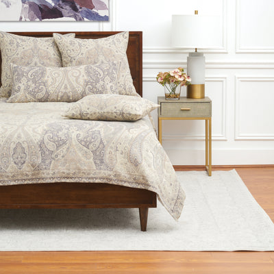 100% cotton jacquard woven coverlet with tan paisley design and matching accessories on a bed